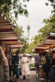 A group of people standing around a market