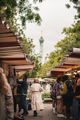 A group of people standing around a market