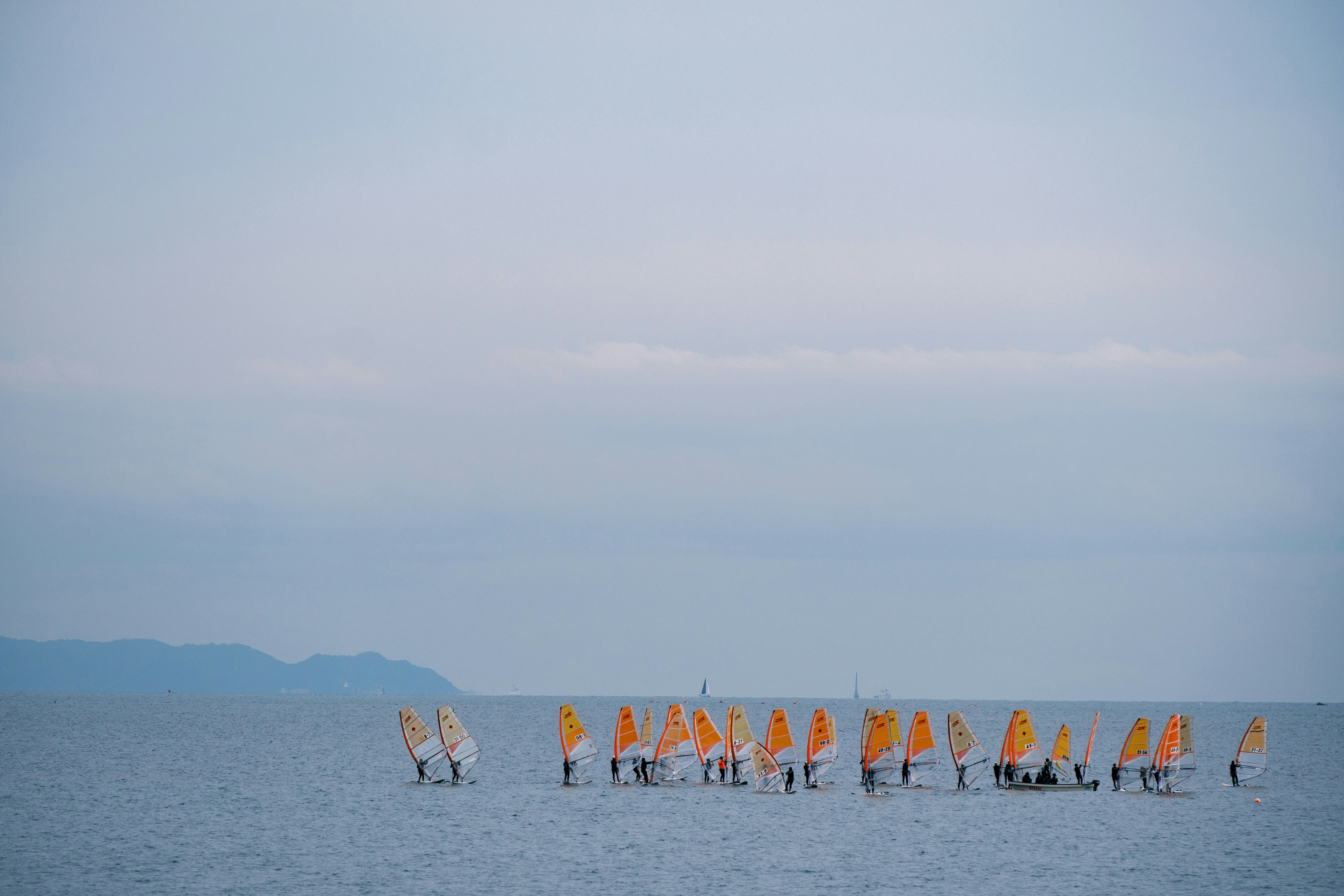 A large body of water filled with lots of orange flags