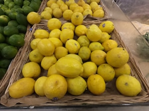 A display of lemons and limes in a grocery store