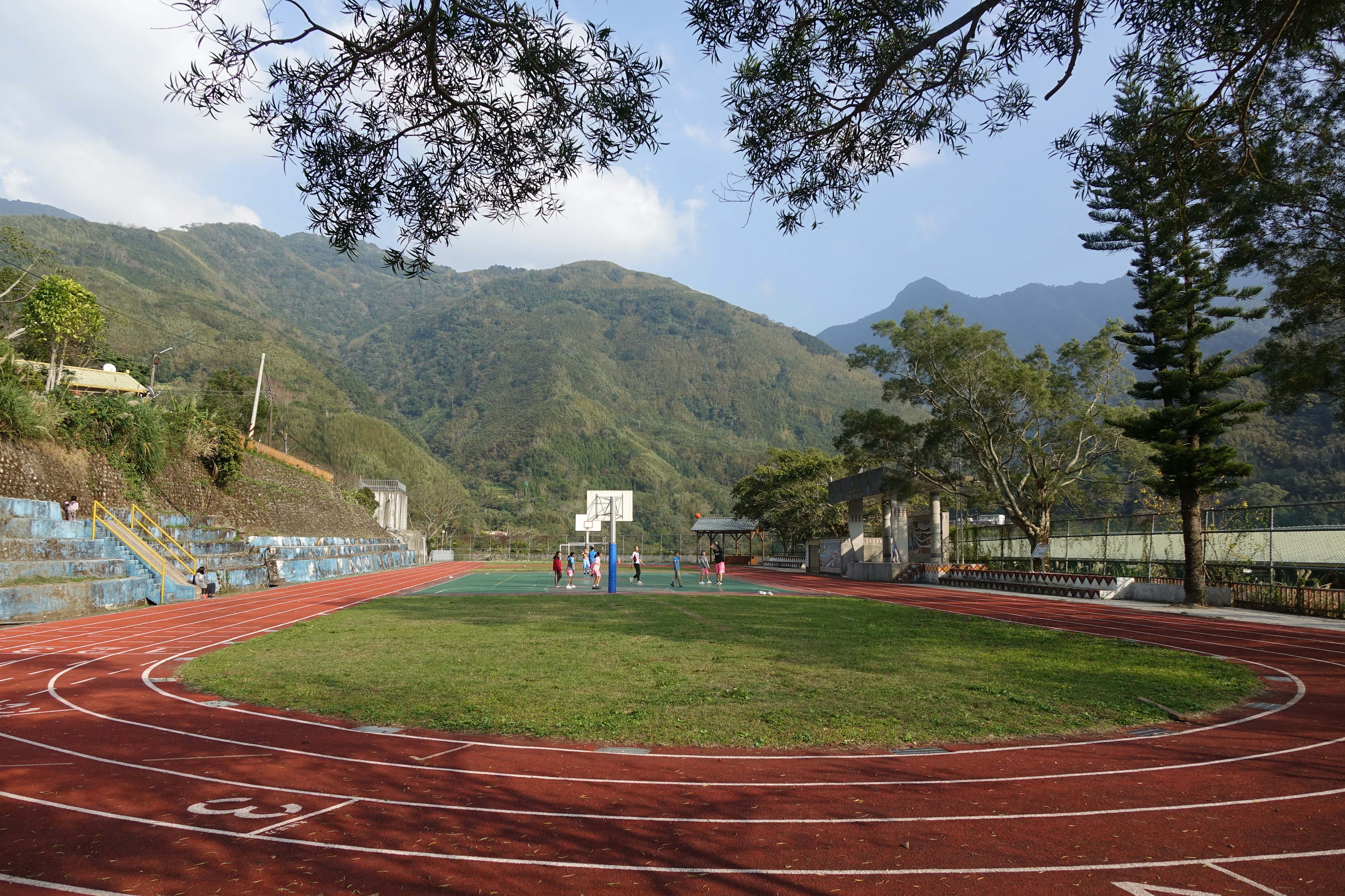 A view of a running track with mountains in the background