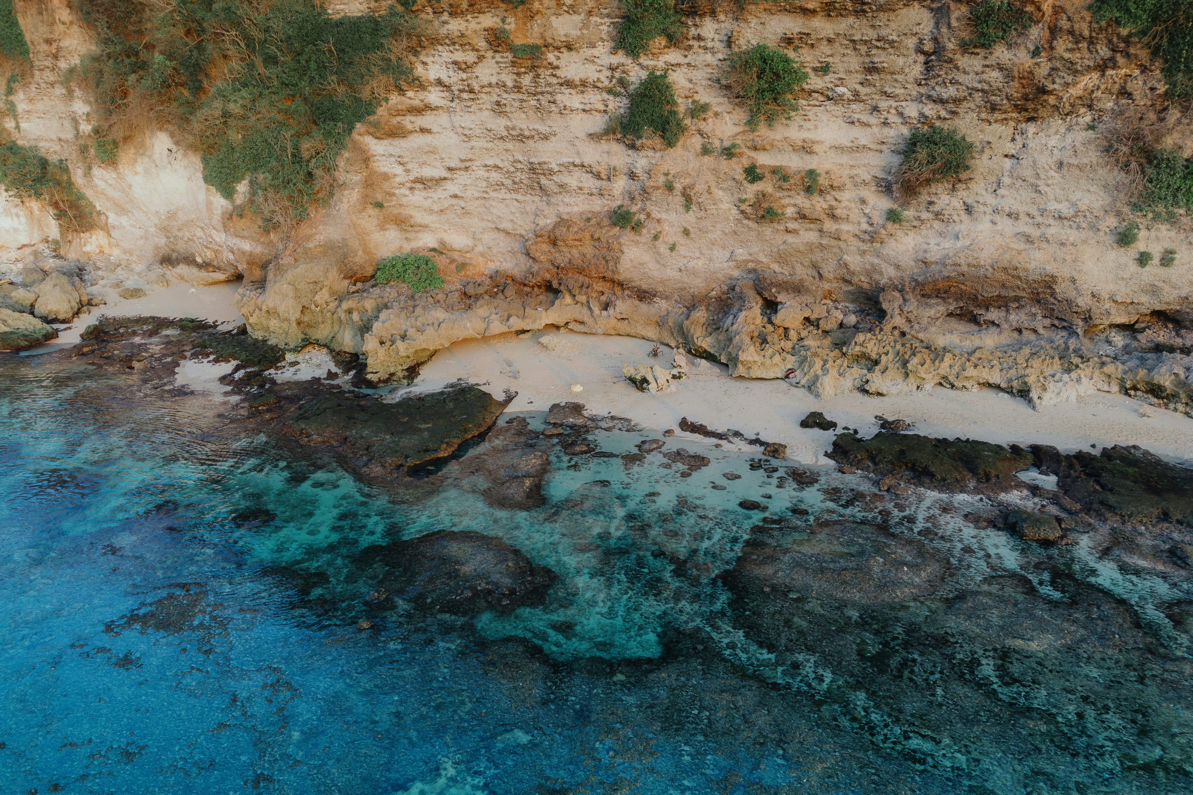 An aerial view of a beach and a cliff