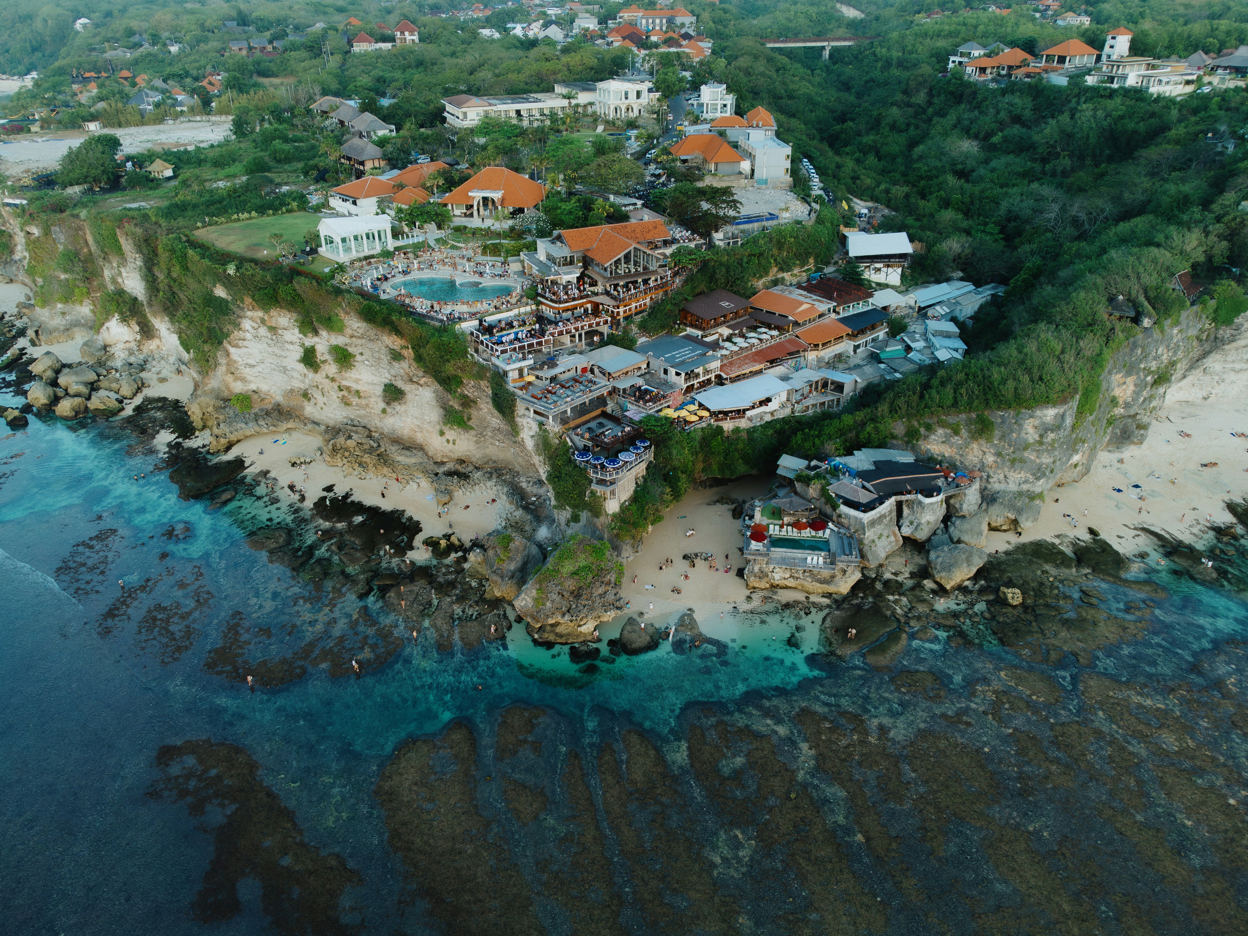 An aerial view of a resort on a cliff overlooking the ocean