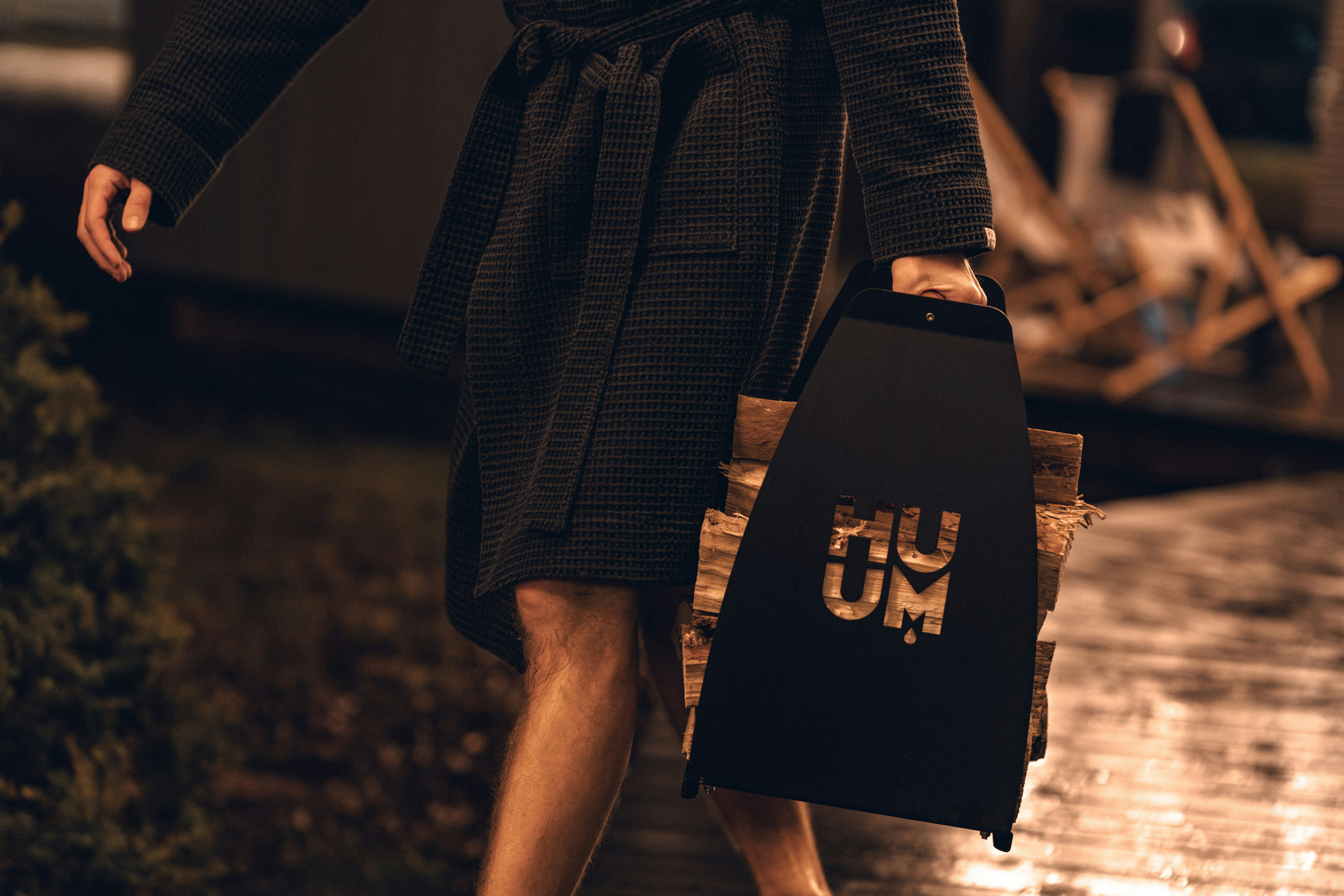 A woman walking down a street holding a suitcase