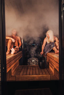 A couple of people that are sitting in a sauna