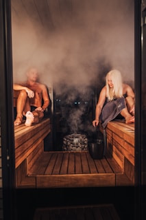 A couple of people that are sitting in a sauna
