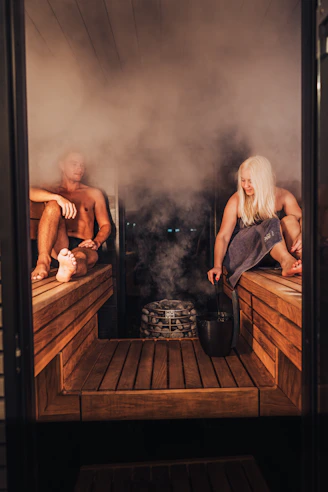 A couple of people that are sitting in a sauna