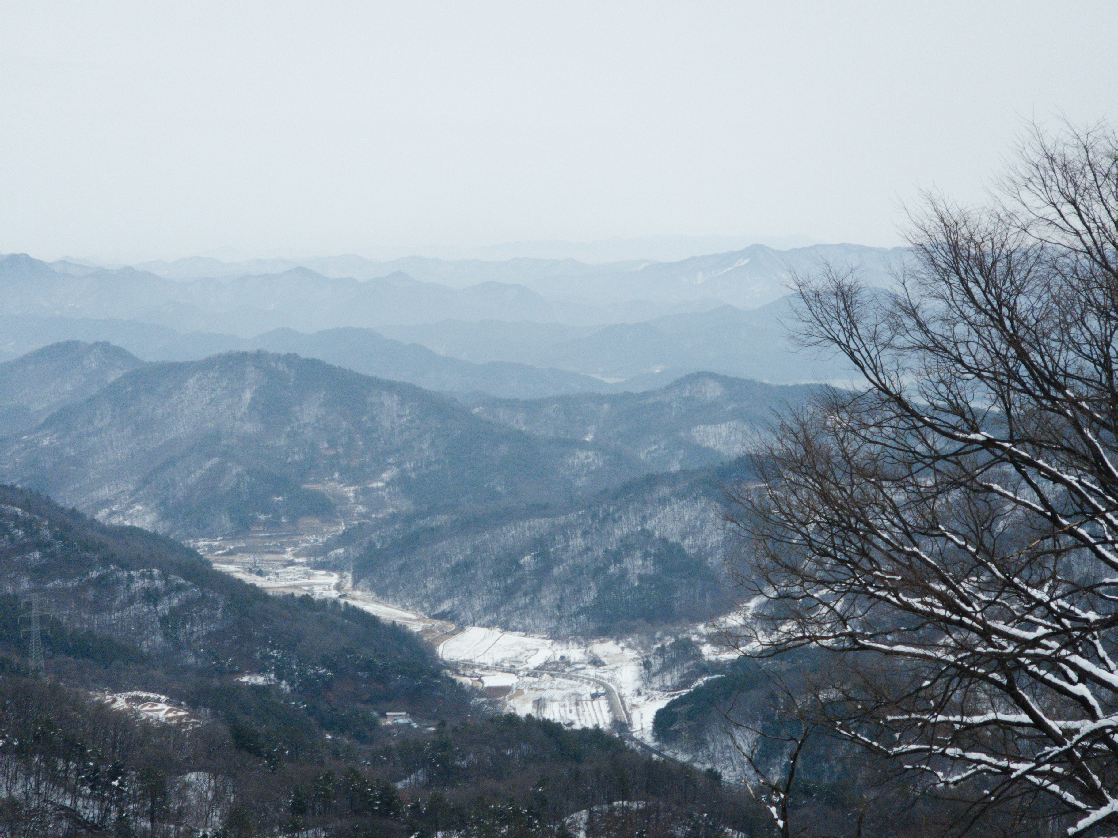 A view of a snowy mountain range from a distance