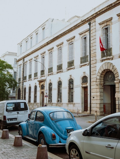 A group of cars parked on the side of a street