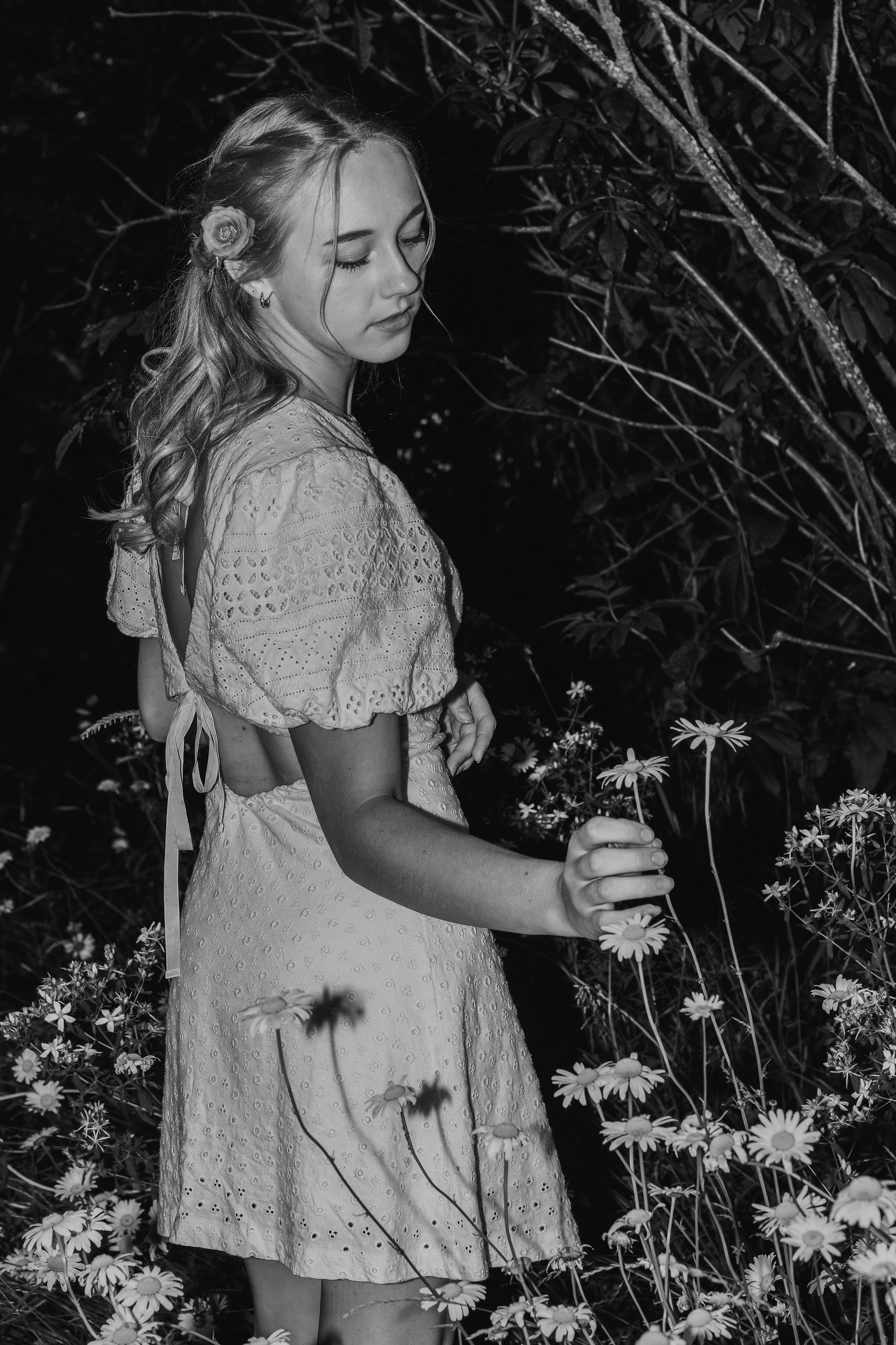 A young girl standing in a field of flowers