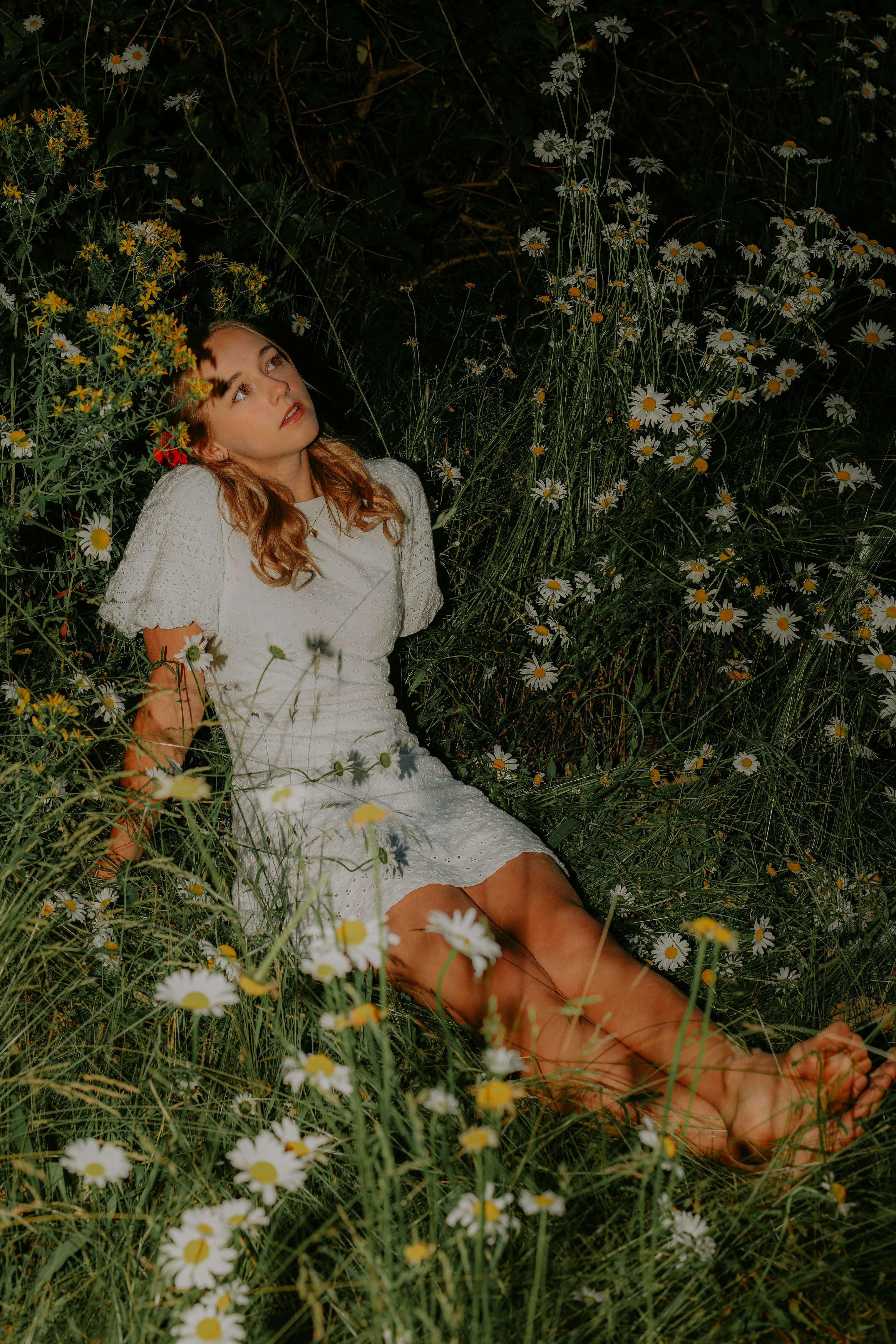 A woman sitting in a field of flowers
