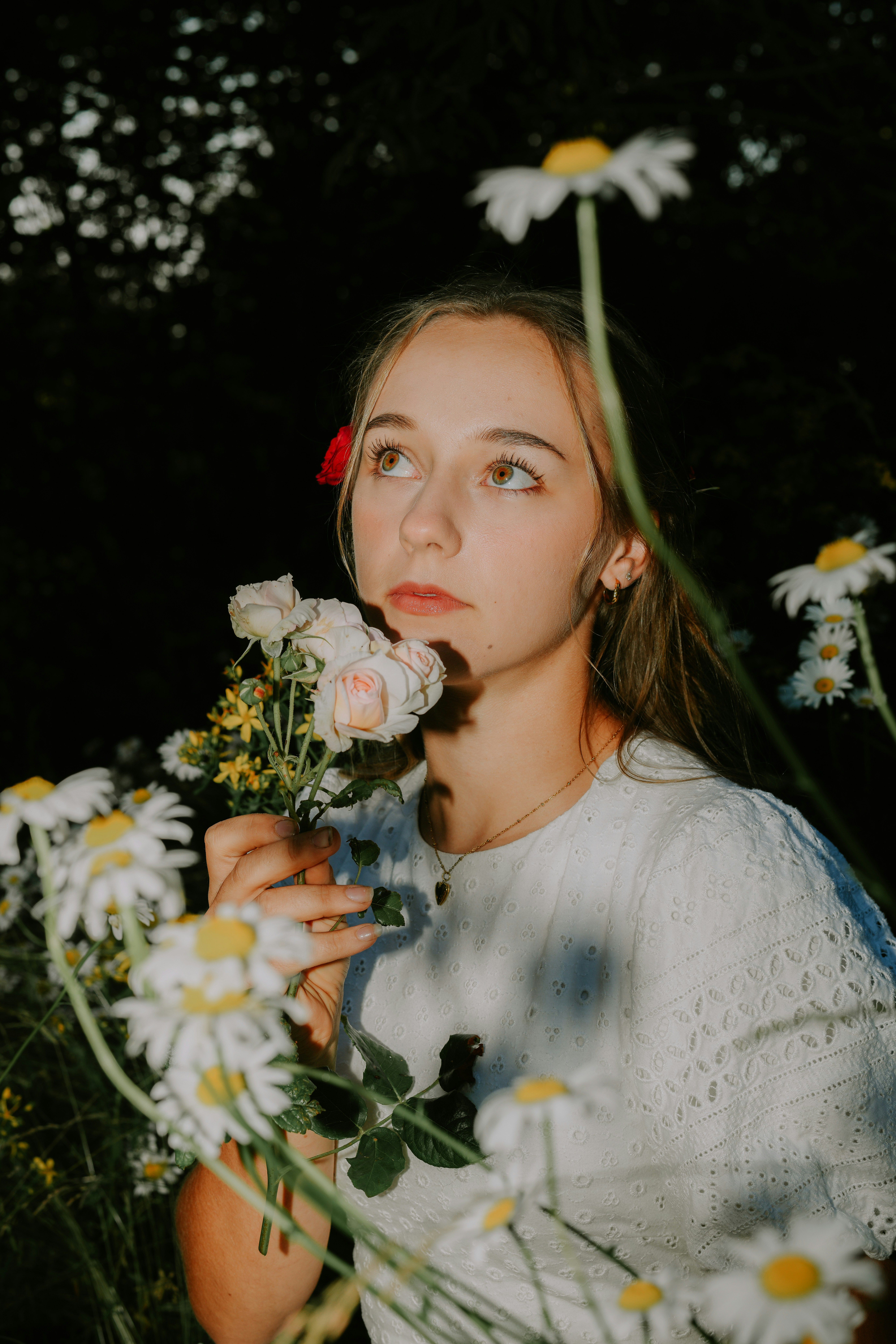 A woman holding a bunch of flowers in her hand
