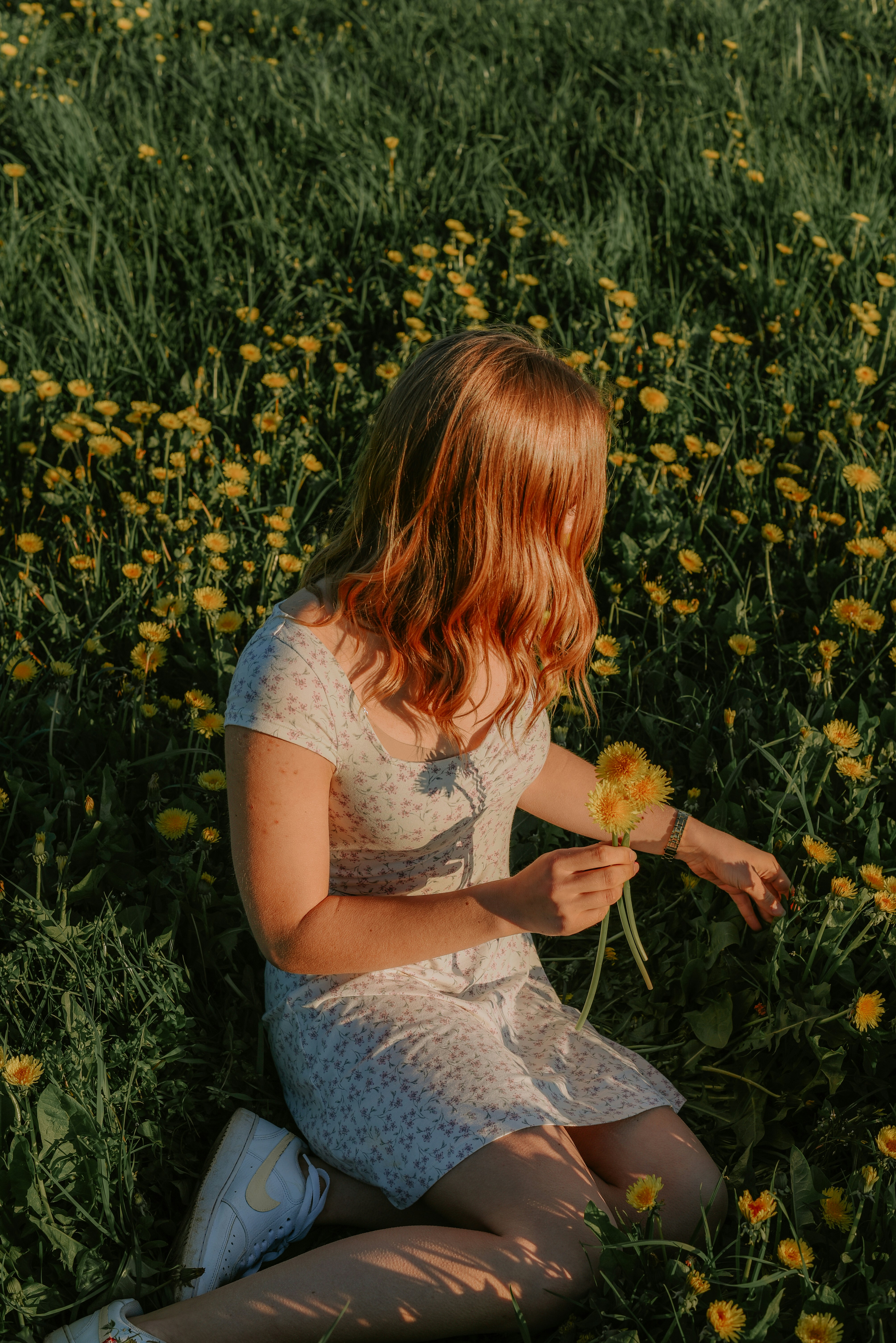 A woman sitting in a field of flowers