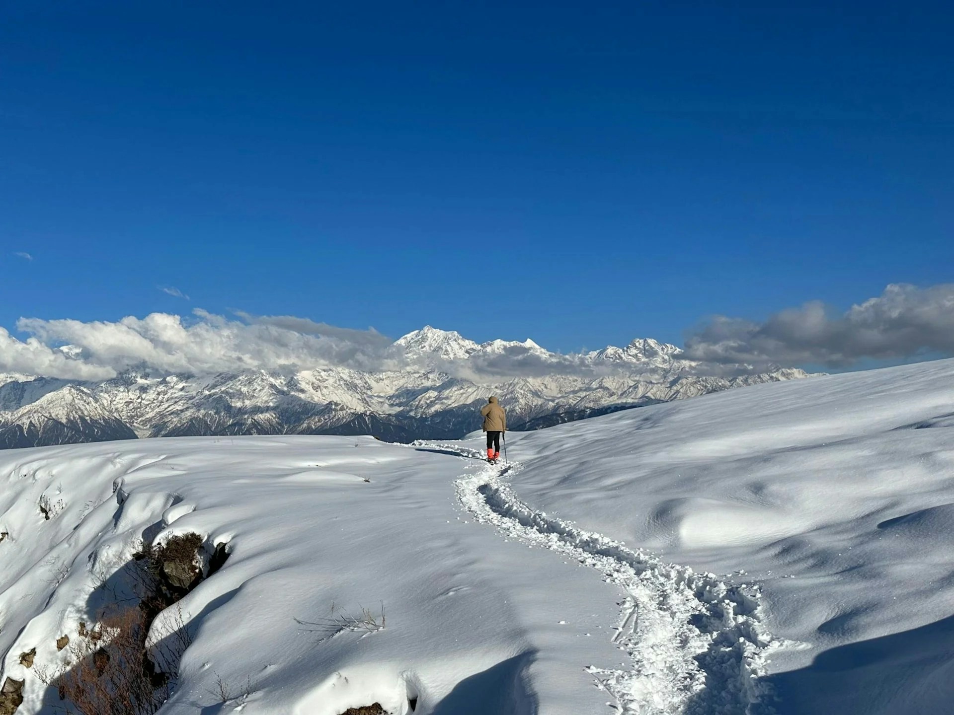 A person standing on top of a snow covered slope