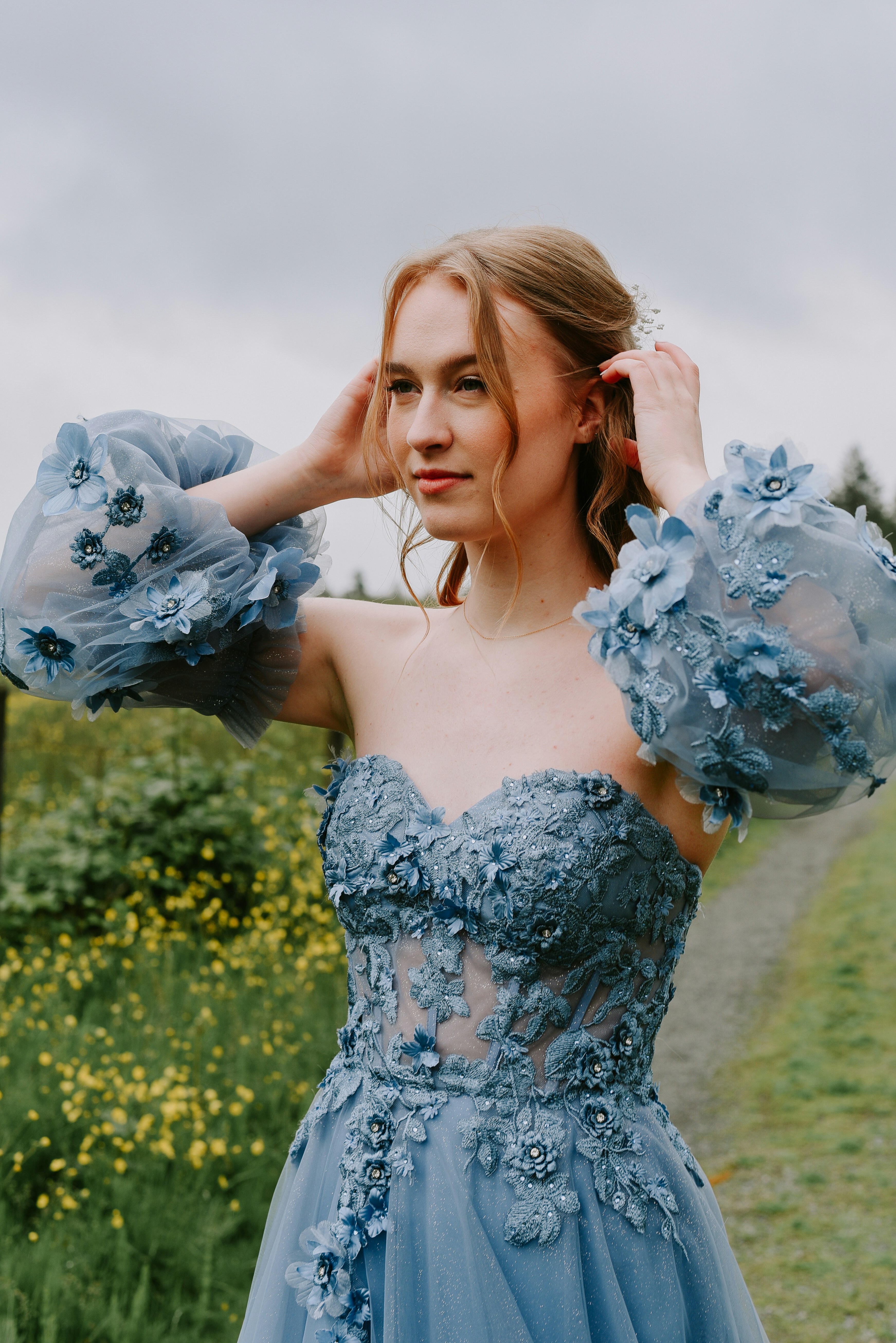 A woman in a blue dress standing in a field