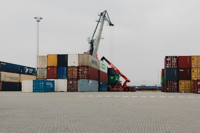 A large crane is in the middle of a parking lot
