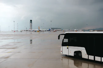 A black and white bus parked in a parking lot