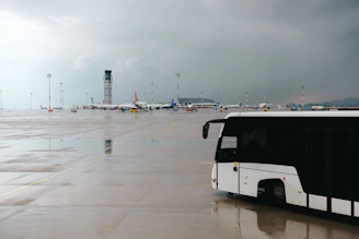 A black and white bus parked in a parking lot