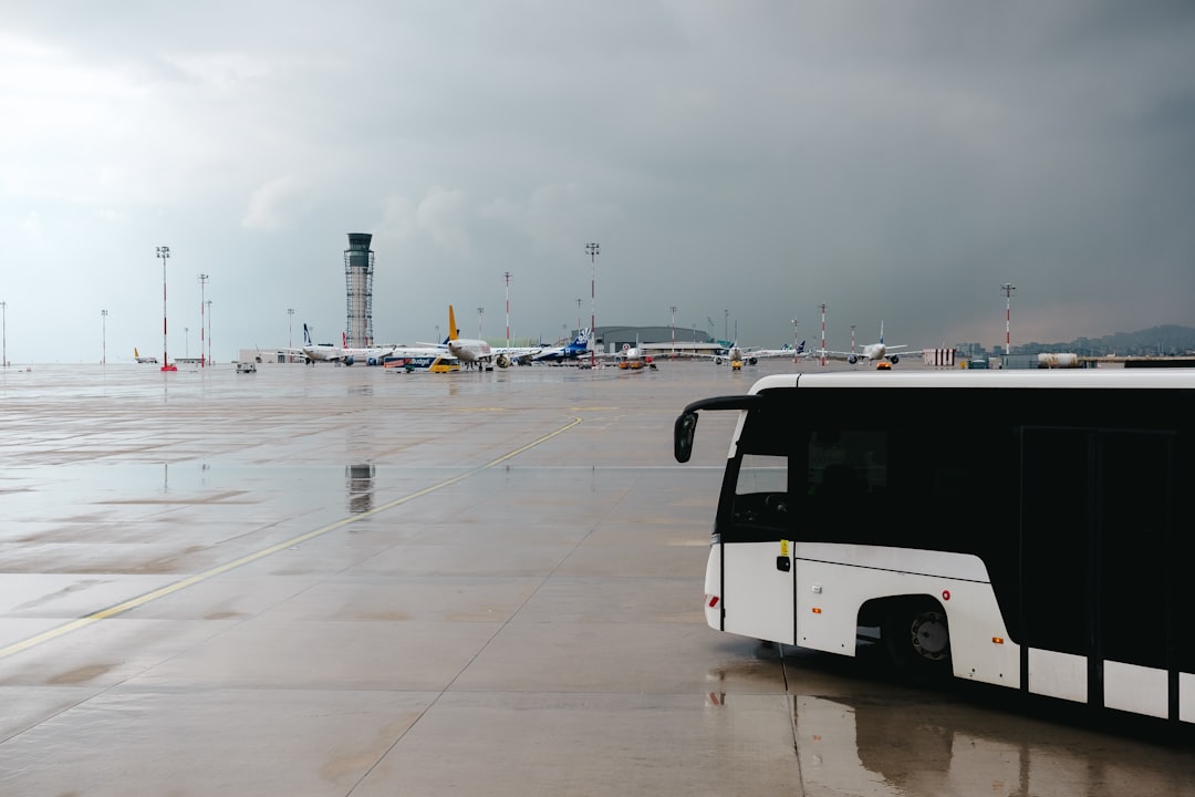 A black and white bus parked in a parking lot,