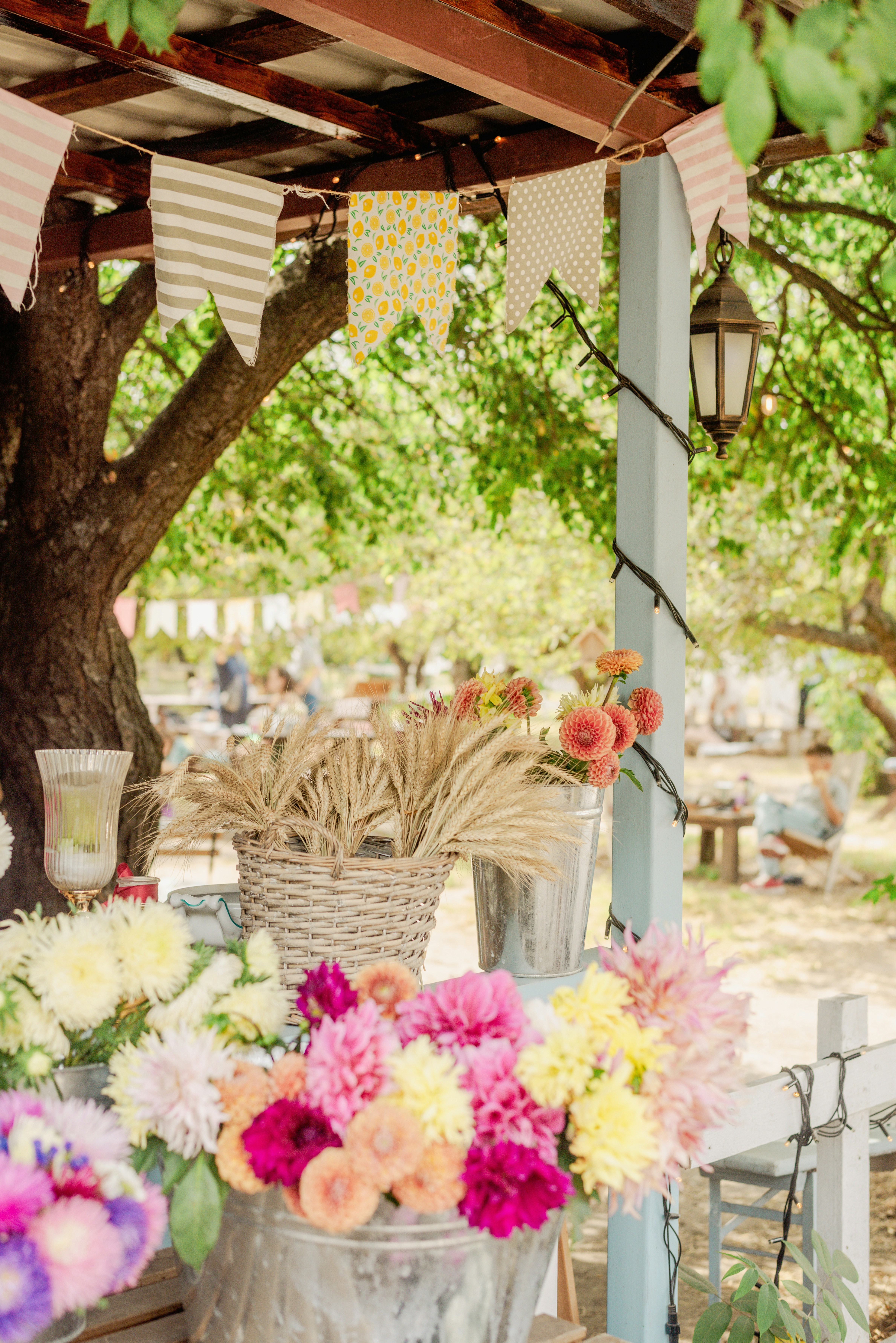 A wooden table topped with buckets filled with flowers