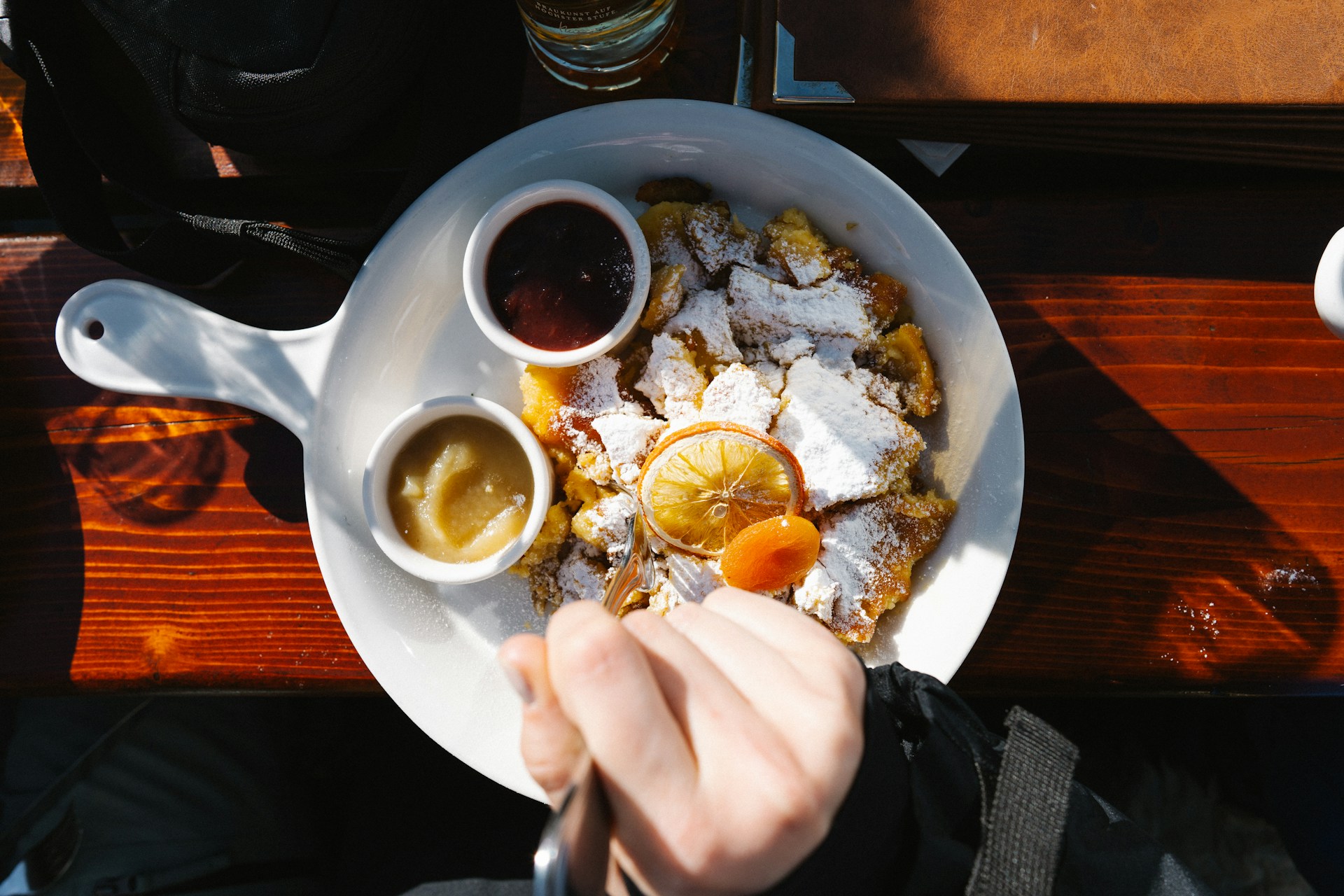 A person is eating a plate of food on a table