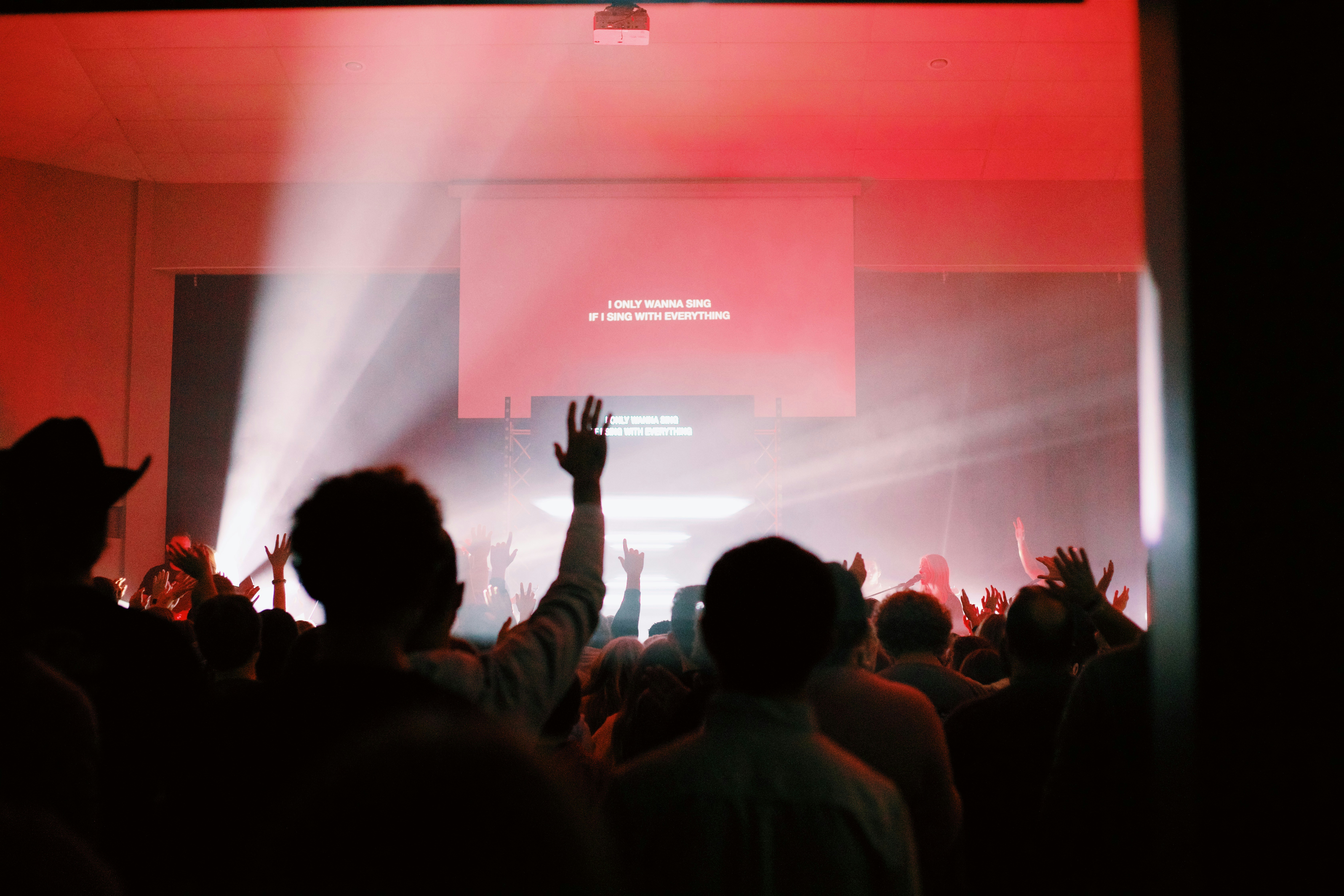 A crowd of people standing in front of a stage
