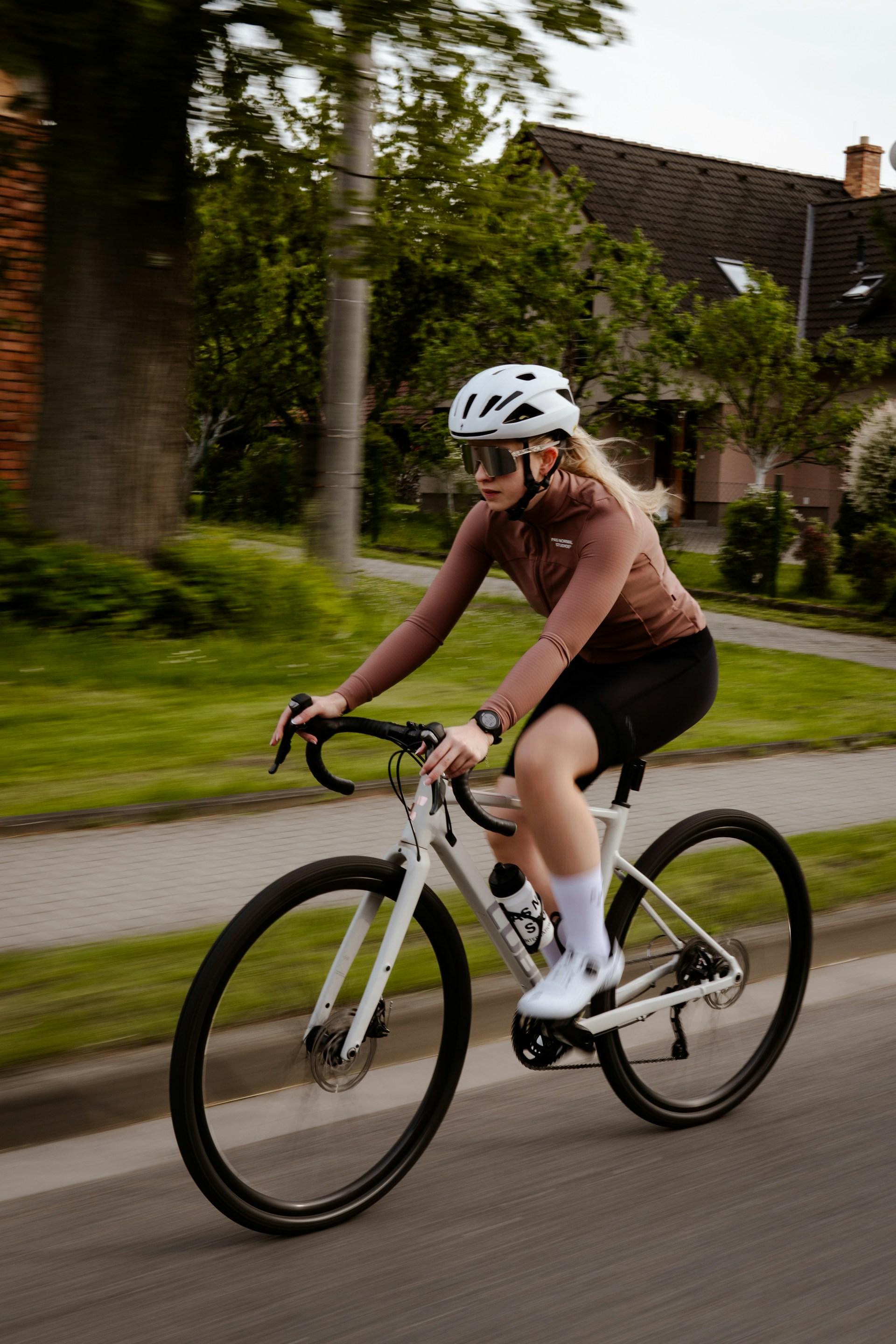 A woman riding a bike down a street