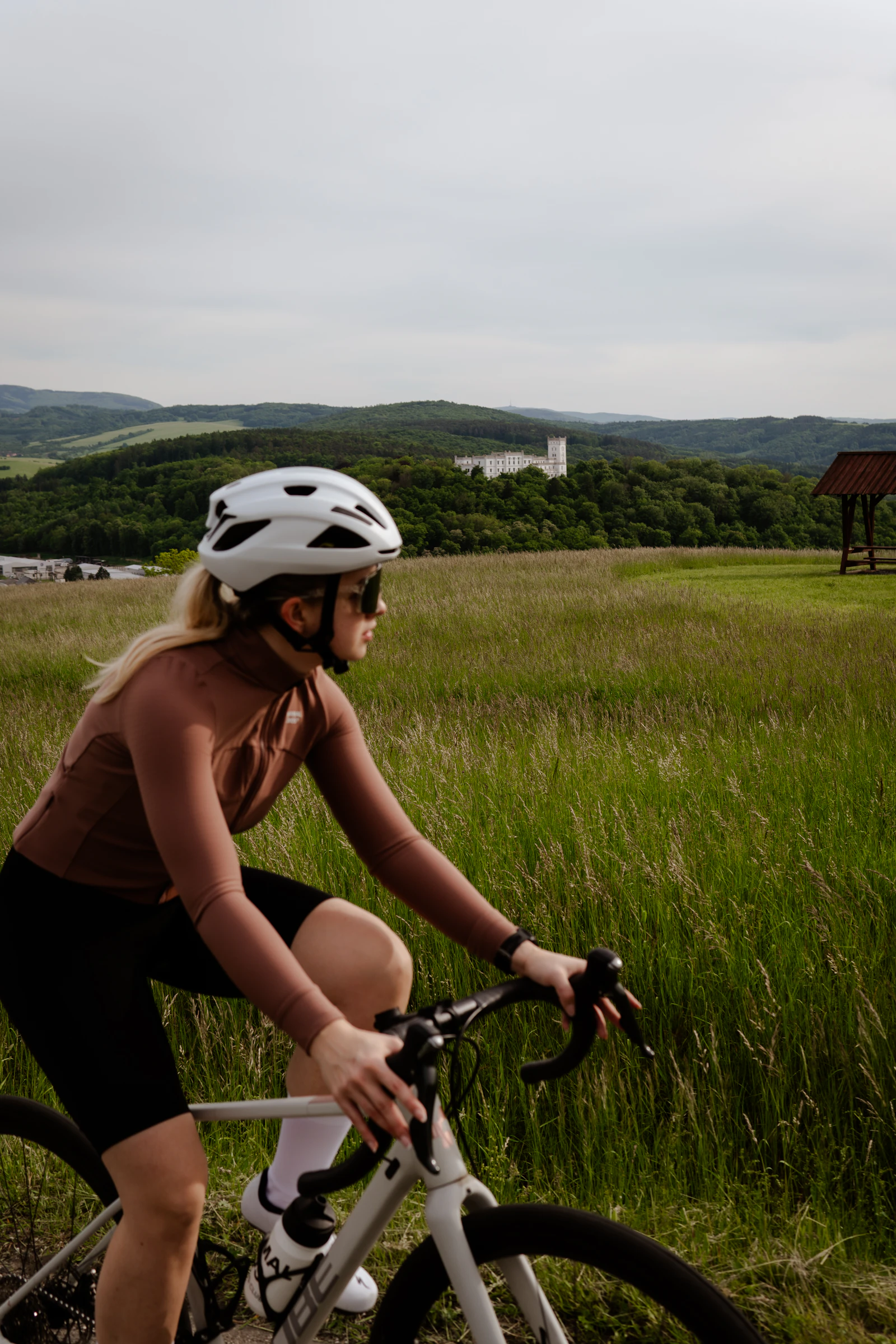 Woman riding a bike down an open road