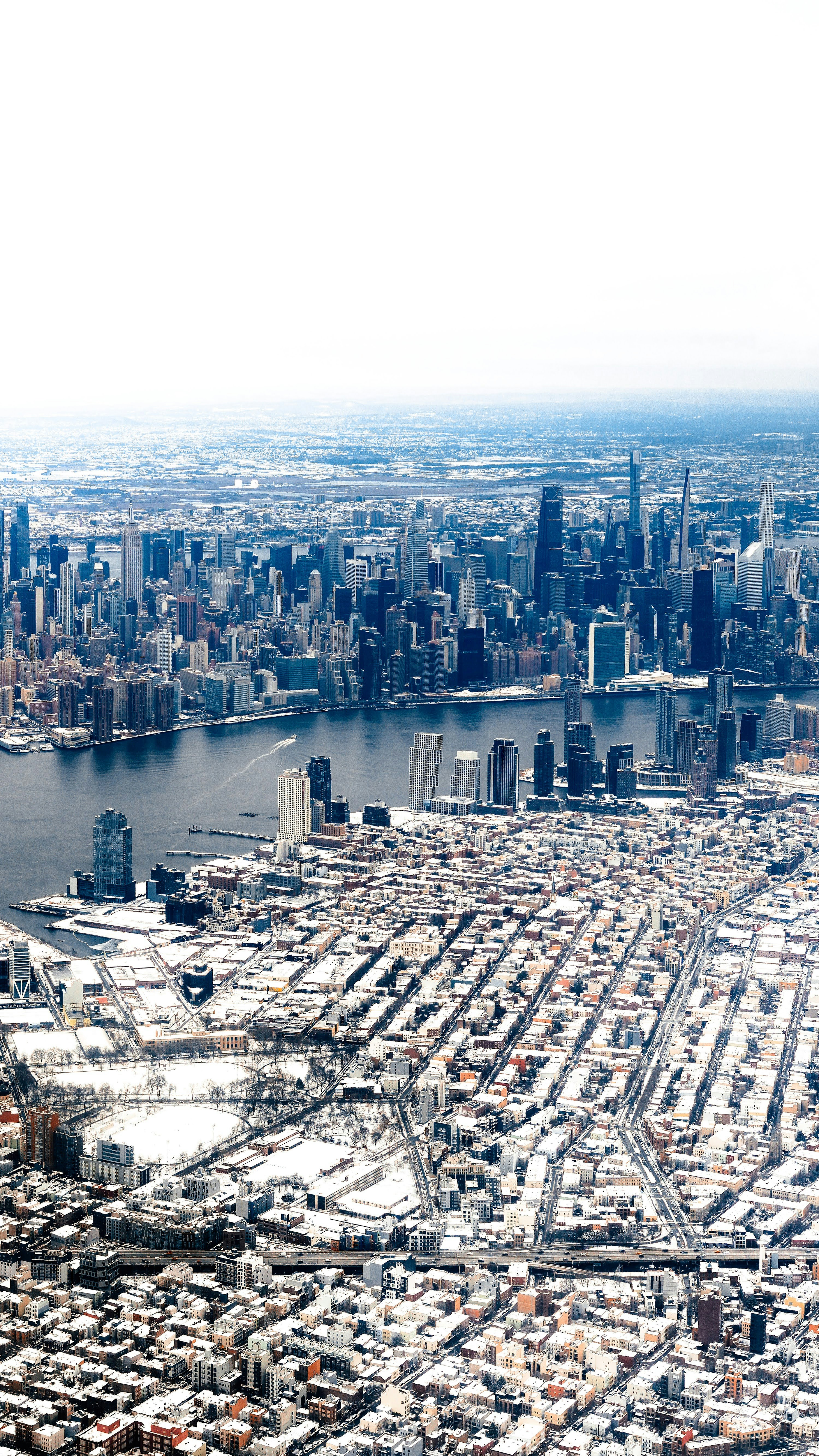An aerial view of a large city and a body of water