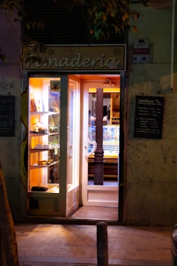 A store front with a lit up door at night