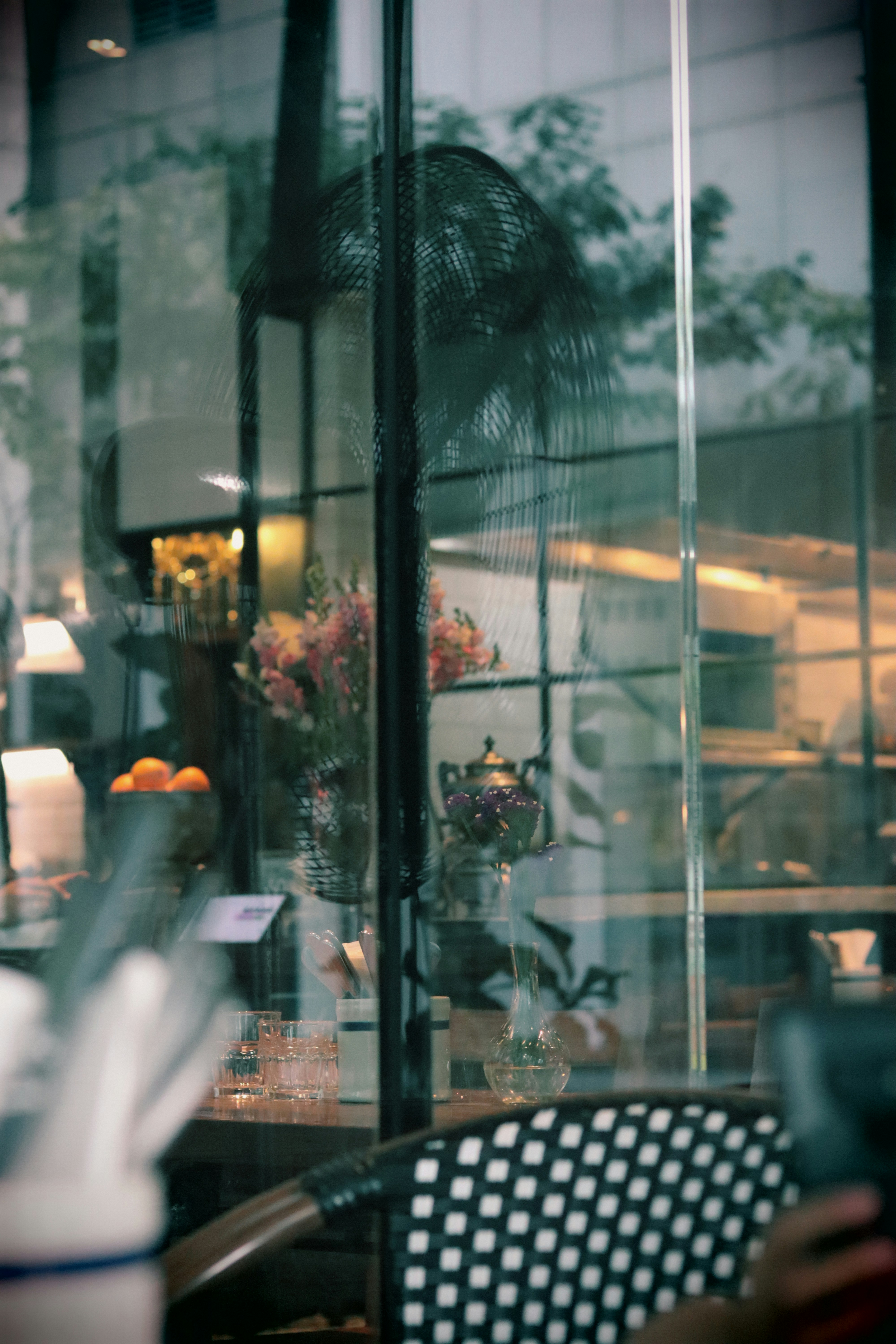 A person sitting at a table in front of a window