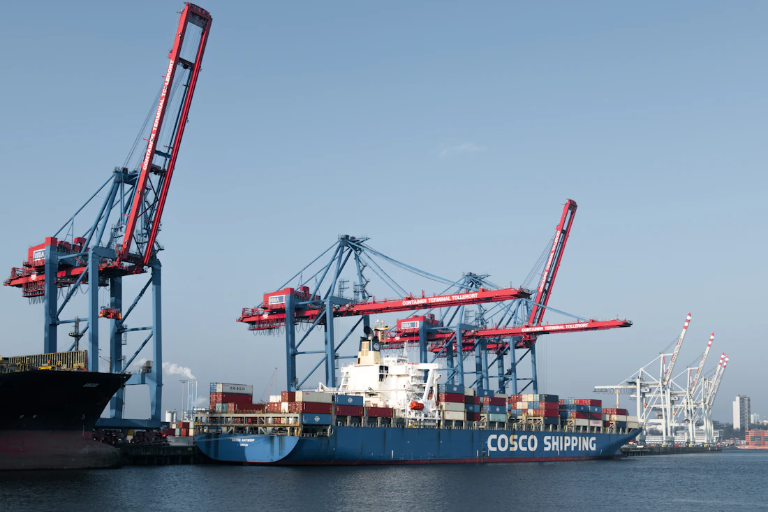 Cargo ship worked in a harbour at dusk