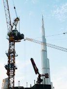 A crane that is standing next to a building in Dubai Burj Khalifa