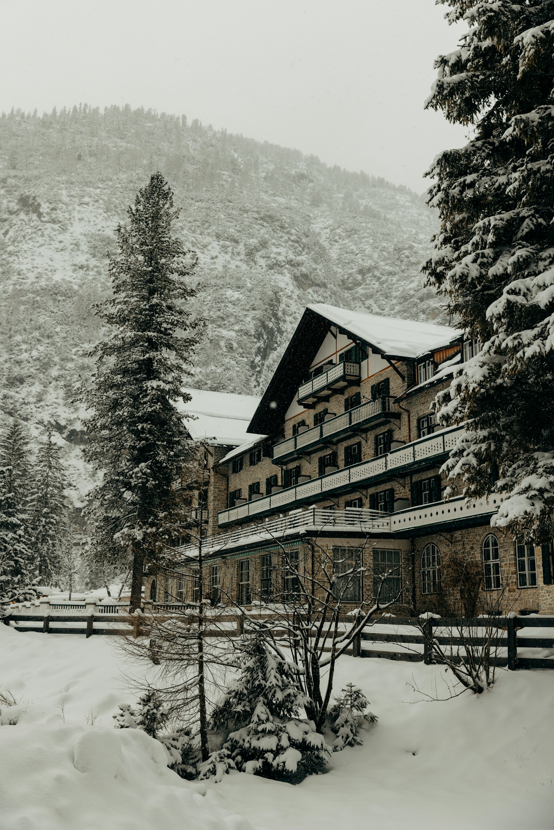 A large building surrounded by snow covered trees