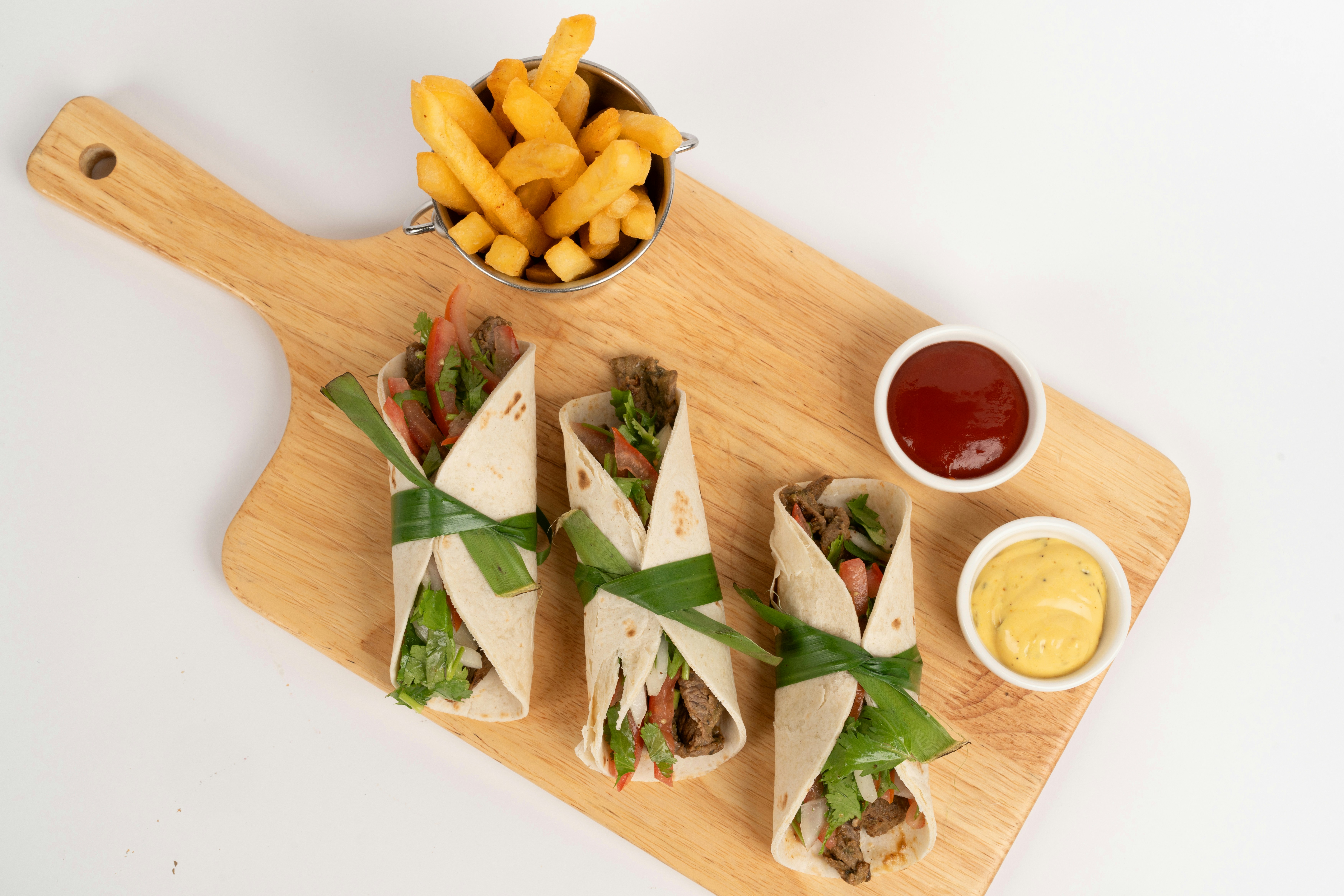 Wrap pieces with fries and dips on a board