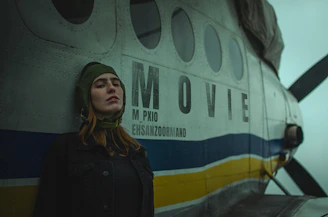 A woman standing in front of an airplane
