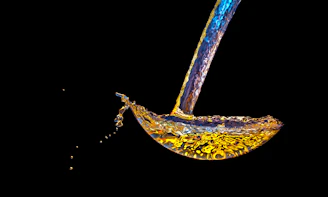A banana being dropped into water by a faucet