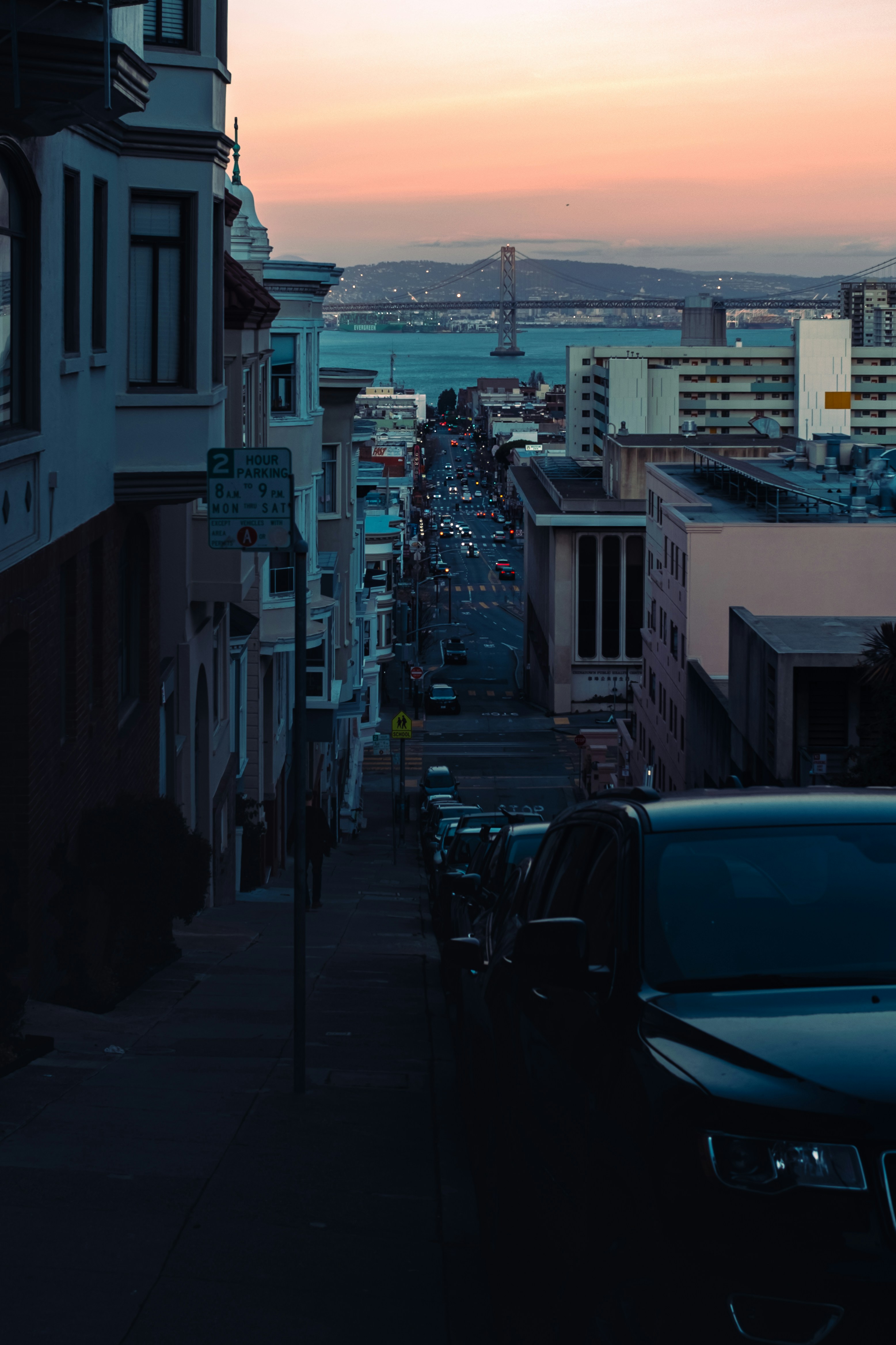 A city street with cars parked on the side of it