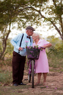 A man and a woman standing next to a bike