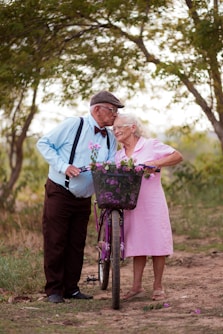 A man and a woman standing next to a bike