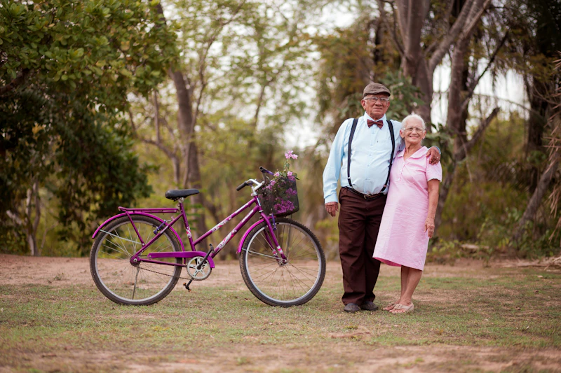 mature couple beside a purple bicycle