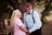 A man and woman standing next to each other near a tree