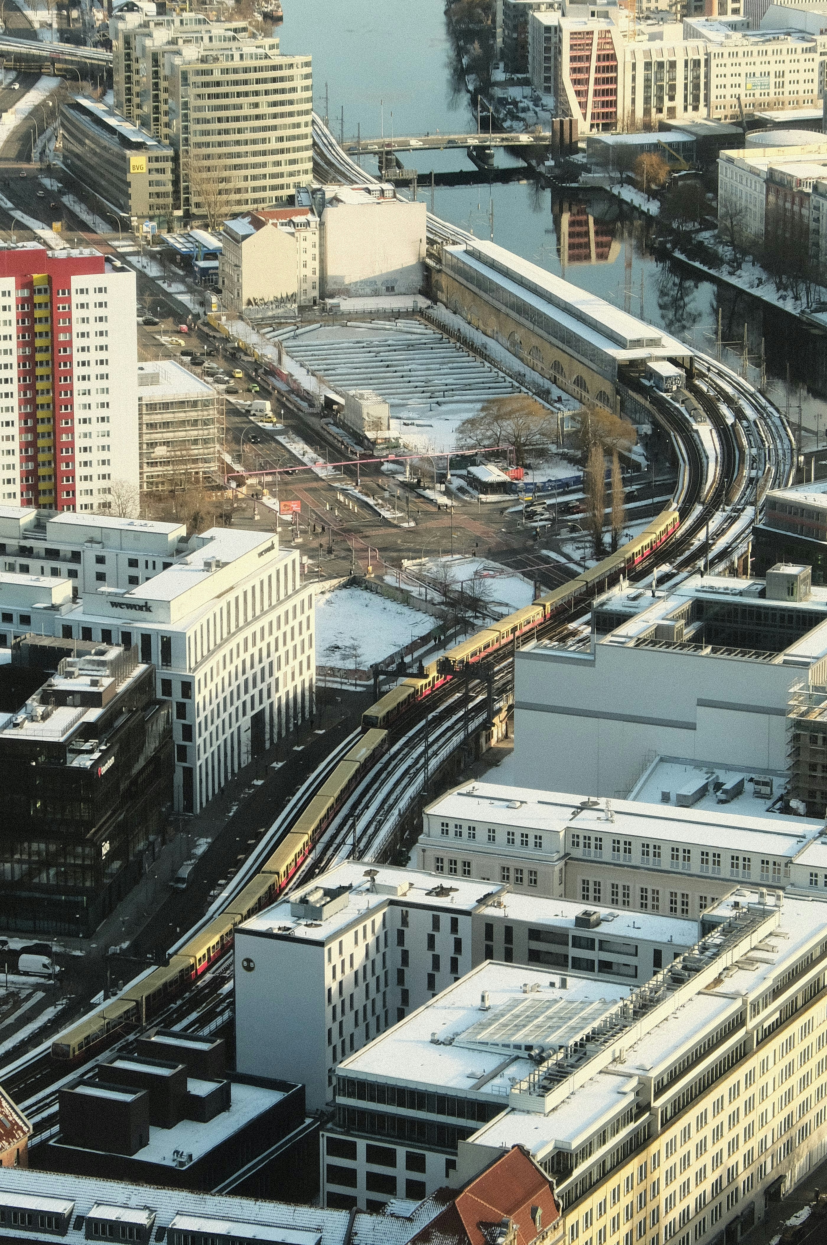 An aerial view of a city with a train on the tracks