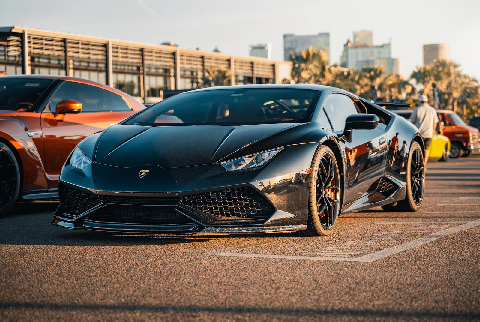 Black Lamborghini parked in golden evening light