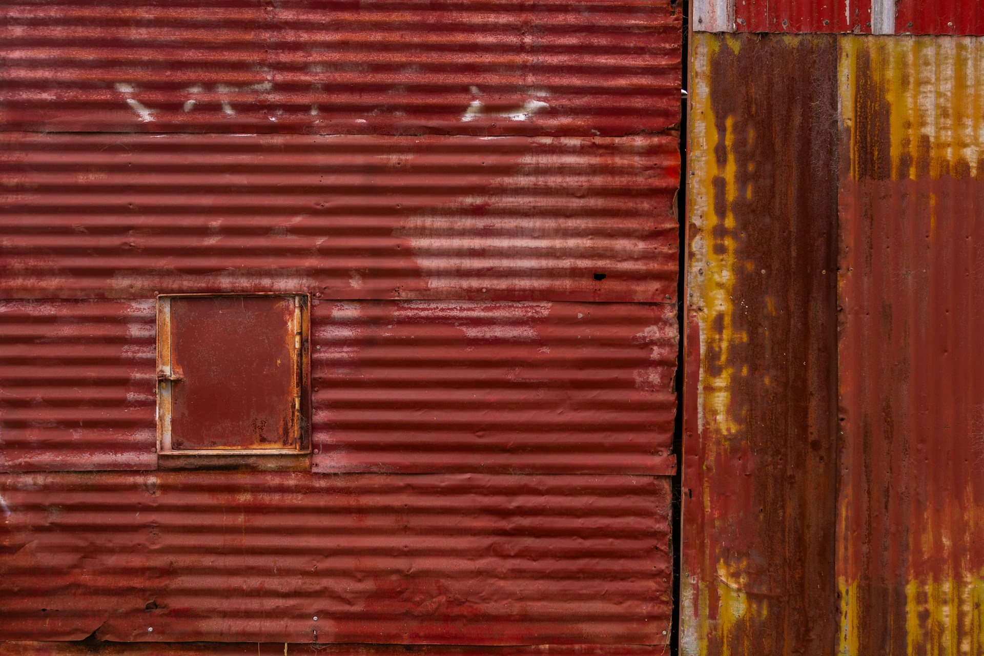 A red building with a red fire hydrant in front of it