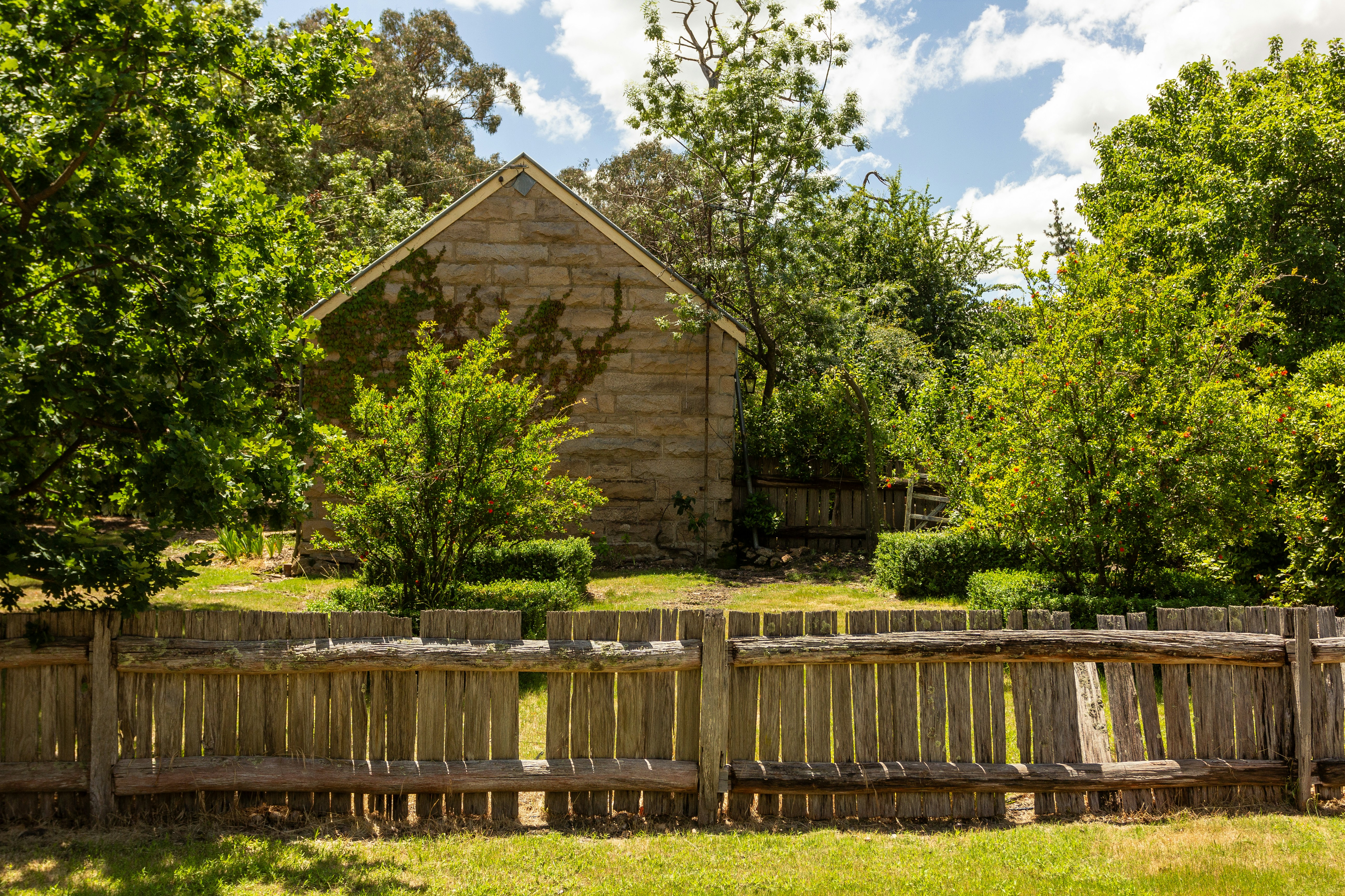 A wooden fence sitting in front of a wooden house