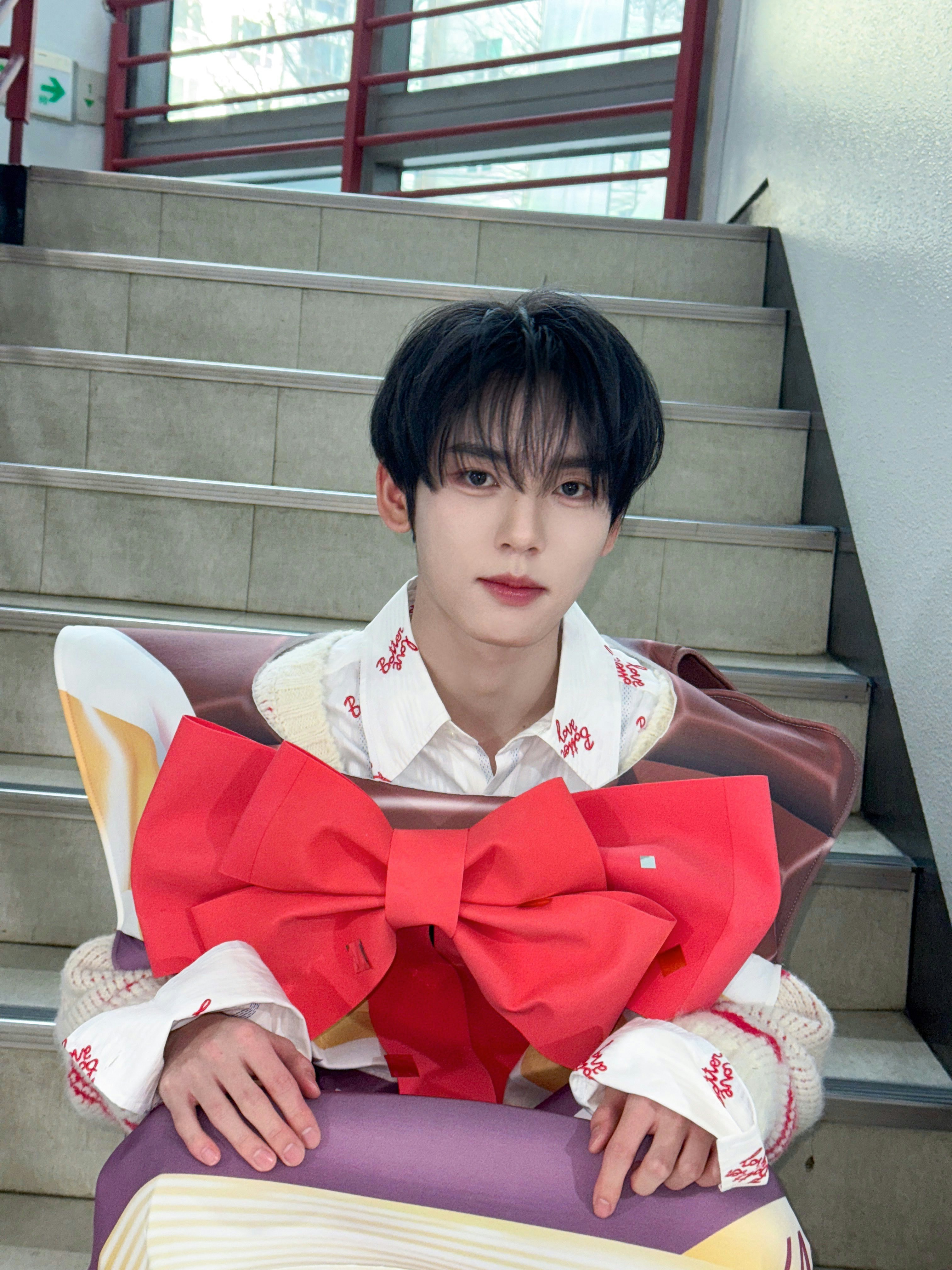 A man sitting on a chair with a book in his lap