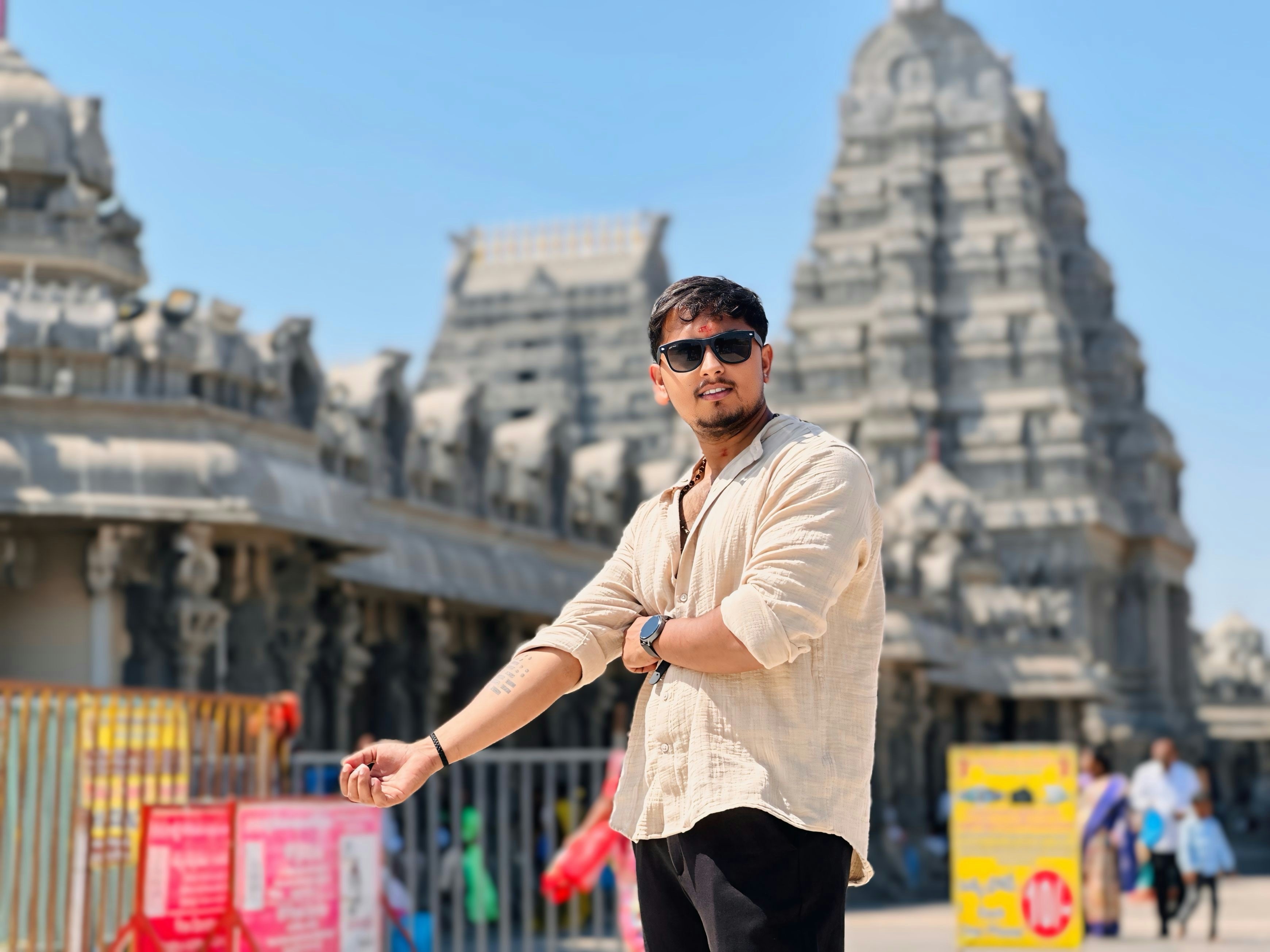 A man standing on a skateboard in front of a building