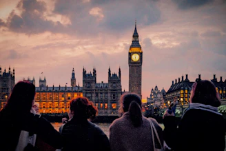 A group of people standing in front of a clock tower