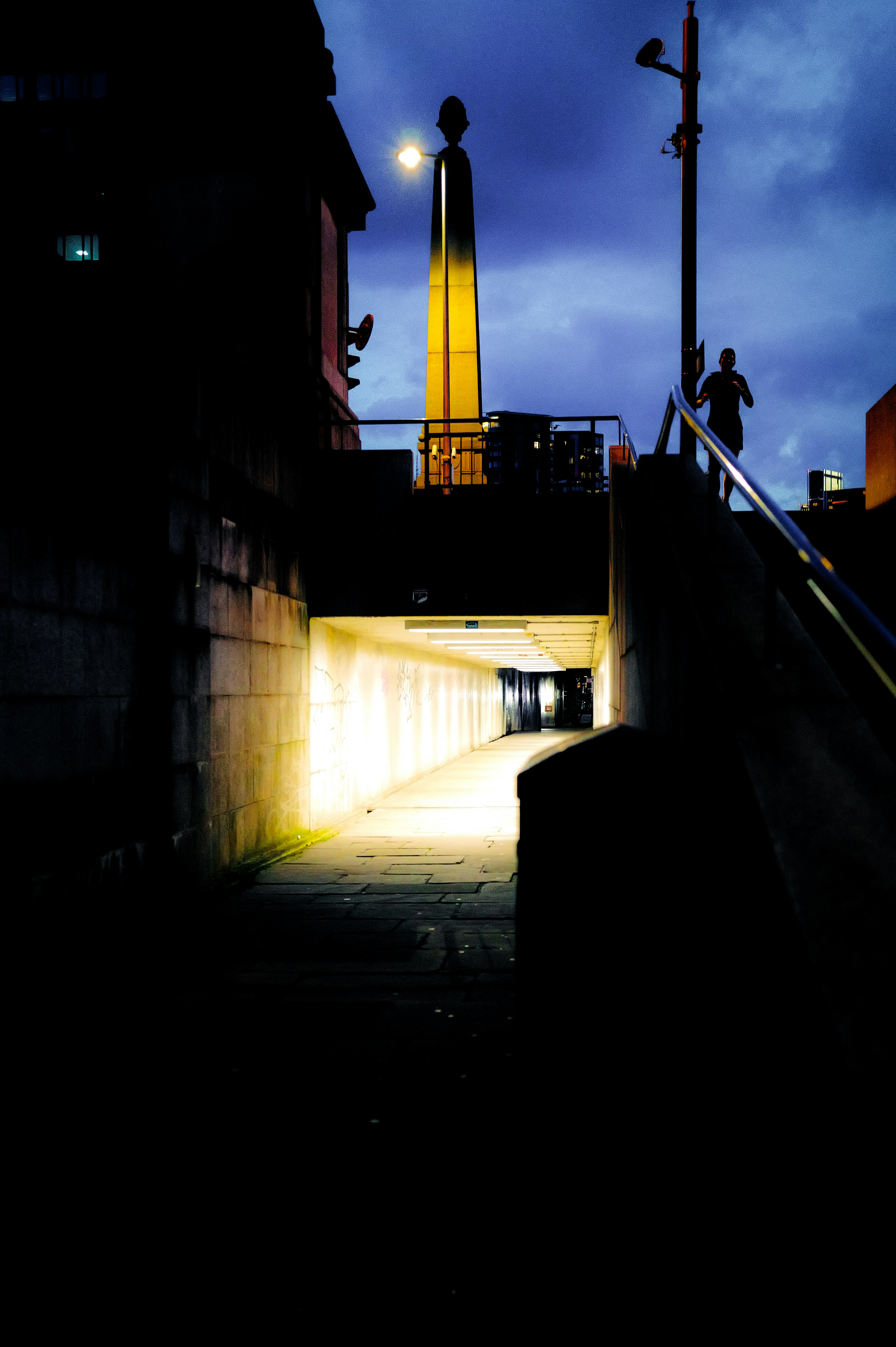 A person is walking up a ramp at night